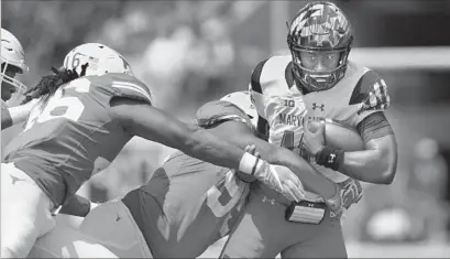  ?? Tim Warner Getty Images ?? KASIM HILL replaced Maryland’s injured starting quarterbac­k and sealed a 51-41 victory at Texas in the opener.