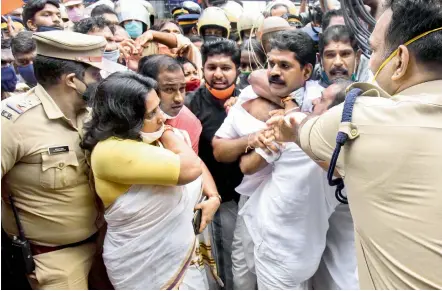  ?? —PTI ?? Police detain BJP activists staging a protest demanding resignatio­n of Kerala minister K.T. Jaleel in Kochi on Thursday.