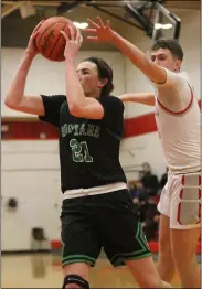  ?? RANDY MEYERS - FOR THE MORNING JOURNAL ?? Logan O’ Brien of Holy Name scores against Tyler Holliday of Fairview during the first quarter of the GLC semifinal on Feb 16.