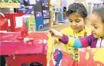  ?? MORNING CALL FILE PHOTO ?? Lianna Colon, left, and Kiara Altamirano look at a cardboard challenge project they and other Head Start students made in 2018 at Community Services for Children, Allentown.