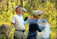  ?? AP-Robert F. Bukaty ?? Nick Haddad, left, watches a captive-bred female St. Francis’ satyr butterfly fly off after it was released into the wild at Fort Bragg in North Carolina on Monday, July 29, 2019. Haddad has been studying the rare butterfly for more than 15 years.