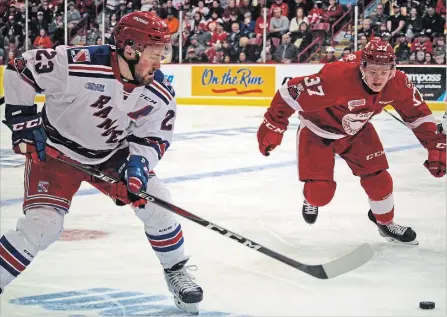  ?? JEFFREY OUGLER THE SAULT STAR ?? Sault Ste. Marie Greyhounds winger Ryan Roth and Kitchener Rangers winger Adam Mascherpur­sue the puck during first-period action.