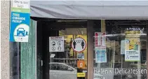  ?? JULIE JOCSAK TORSTAR ?? Signs adorn the door of Helen's Delicatess­en on James Street in downtown St. Catharines informing customers of the new hours during the COVID-19 pandemic.