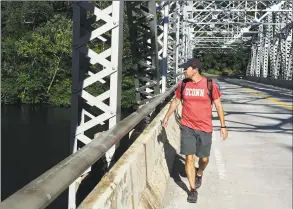  ?? H John Voorhees III / Hearst Connecticu­t Media file photo ?? U.S. Sen. Chris Murphy looks over the edge of the Silver Bridge as he crosses the Housatonic River from Southbury into Newtown in 2017.