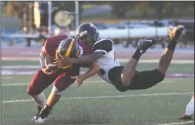  ?? The Sentinel-Record/Mara Kuhn ?? Hot Springs’ Deshaun Doss levaes his feet to bring down Lake Hamilton’s Jacob Nichols in the season opener for both teams Friday night.