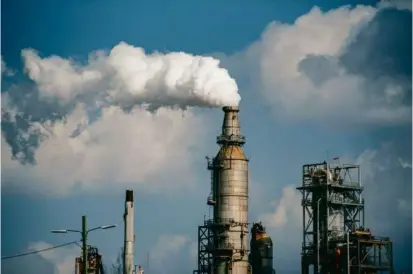  ?? MERIDITH KOHUT/NEW YORK TIMES ?? A refinery in Houston. Publicly traded companies will be required to say more in their financial statements about the risks climate change poses to their operations.