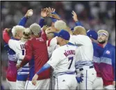 ?? ?? Puerto Rico players celebrate a 10-0 win over Israel with an 8-inning, run-rule walk off and a combined perfect game during a World Baseball Classic game, Monday, in Miami.