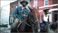  ??  ?? Harp (Idris Elba) tries to connect with his estranged 15-year-old son Cole (Caleb McLaughlin) in “Concrete Cowboy,” a fictional story set around the real subculture surroundin­g Philadelph­ia’s Fletcher Street Stables, one of the oldest and last-remaining of the city’s inner-city stables.