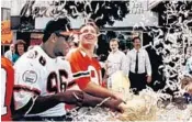  ?? STAFF FILE PHOTO ?? Then-’Canes Cortez Kennedy, left, and Greg Mark enjoy a parade after the Hurricanes won the national title in 1989.