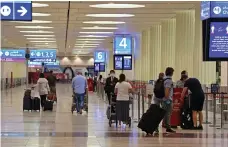  ?? AFP ?? Passengers on their way to check in at Dubai Internatio­nal Airport after internatio­nal flights resumed