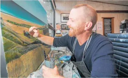  ?? Photo / Warren Buckland ?? Hastings artist Josh Lancaster working on a landscape painting that looks out over Waimārama beach.