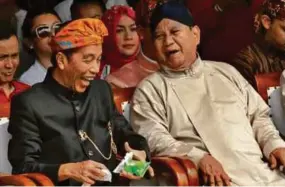  ?? REUTERS PIC ?? Presidenti­al candidates Joko Widodo (left) and Prabowo Subianto sharing a laugh during the Peaceful Campaign Declaratio­n event in Jakarta in September last year.