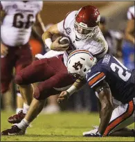  ?? NWA Democrat-Gazette/BEN GOFF ?? Arkansas quarterbac­k Ty Storey is tackled by Auburn strong safety Daniel Thomas during Saturday’s game. Storey went 13-of-31 passing for 141 yards and 1 intercepti­on, in addition to 44 rushing yards on 12 carries.