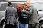  ?? WIN MCNAMEE / GETTY IMAGES ?? A student from Great Mills High is comforted while being picked up at Leonardtow­n High after Tuesday’s school shooting at Great Mills High in Leonardtow­n, Maryland.