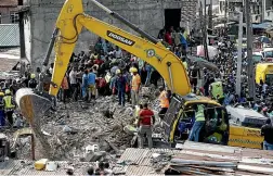  ?? AP ?? Emergency services attend the scene after a school building collapsed in Lagos.