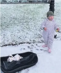  ??  ?? • Ada, aged 2, going sledging for the first time