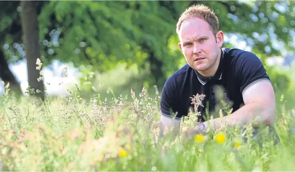  ??  ?? Local resident Gary Aitchison in the long grass off Graham Street.