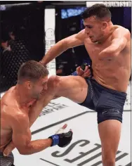  ?? Chris Unger / DWTNCS LLC via Getty Images ?? Nick Newell knees Alex Munoz in their lightweigh­t fight during Dana White’s Tuesday Night Contender Series at the TUF Gym in 2018 in Las Vegas.