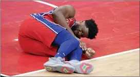  ?? NICK WASS — THE ASSOCIATED PRESS ?? Sixers center Joel Embiid grimaces after an injury during last Friday’s game against the Wizards in Washington.