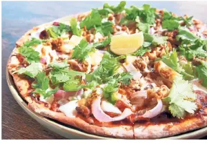  ??  ?? An Asian version of the Hawaiian pizza, the chilli chicken pizza is built on ayam percik, a classic Malaysian dish.