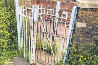  ??  ?? The Victorian kissing gate which has been ripped out... and the gap where it used to be bricked up