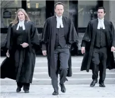  ?? THE CANADIAN PRESS ?? Crown persecutor Doug Taylor, centre, leaves court after Joshua Frank and Jason Klaus were pronounced guilty by a judge in Red Deer, Alta., on Jan. 10, 2018.