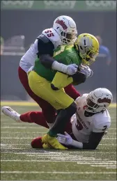  ?? ANDY NELSON — THE ASSOCIATED PRESS ?? Oregon quarterbac­k Anthony Brown (13) is wrapped up by Fresno State tackle Leonard Payne (55) and defensive end Aaron Mosby (3) during the first quarter of an NCAA college football game, Saturday in Eugene, Ore.
