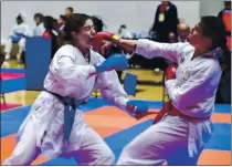  ?? PHOTO BY SONNY LOPEZ ?? Kierra MacKenzie, right, scores a hit against Kelara Madani in a Suzuki Cup match in Addison, Texas, in December 2019. MacKenzie competed in the tournament again this December and won a gold medal.