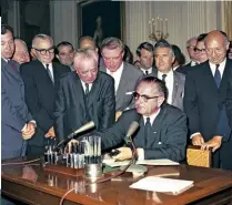  ??  ?? FRONT OF THE BUS Integratio­n became normal in Charlotte, which made the city exceptiona­l. Clockwise from above: Rosa Parks in the front of a bus in Alabama in 1956, President Johnson signs the Civil Rights Act in 1964 and a group of buses move through...