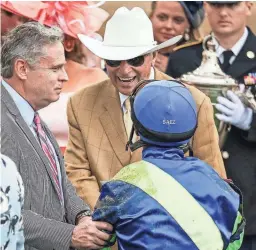  ?? MATT STONE/LOUISVILLE COURIER-JOURNAL ?? Trainer D. Wayne Lukas smiles while shaking hands with jockey Luis Saez with owner Rob Mitchell at left after Secret Oath won the 148th running of Kentucky Oaks on Friday at Churchill Downs.