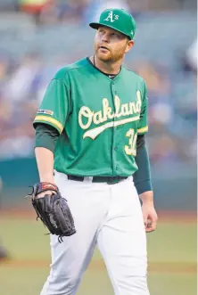  ??  ?? The Brewers got to A’s starter Brett Anderson but he’ll has help coming after Oakland acquired starter Tanner Roark.