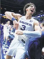  ?? Jeff Dean Associated Press ?? XAVIER’S COLBY JONES and teammates celebrate their upset of second-ranked Connecticu­t.