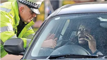  ??  ?? Crackdown: One of the drivers stopped by police after stricter laws came into force