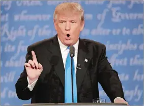  ?? AP PHOTOS ?? Hillary Clinton and Donald Trump locked horns on trade, foreign relations and each other’s scandals during Monday evening’s debate at Hofstra University.