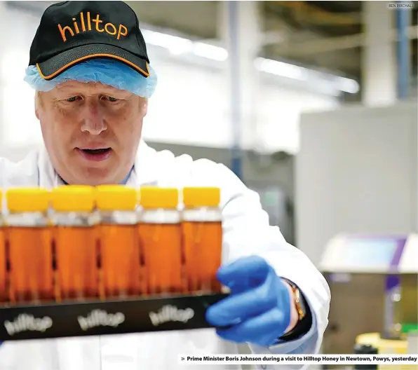  ?? BEN BIRCHALL ?? > Prime Minister Boris Johnson during a visit to Hilltop Honey in Newtown, Powys, yesterday