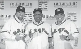  ?? Mary Altaffer Associated Press ?? NEW HALL OF FAME members Jeff Bagwell, Tim Raines and Ivan Rodriguez, from left, will be inducted Sunday into the baseball shrine at Cooperstow­n, N.Y.