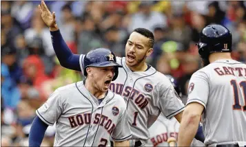  ?? CHARLES KRUPA / AP ?? The Astros’ Alex Bregman (from left) celebrates his game-tying solo home run in the eighth inning with Carlos Correa and Evan Gattis in Houston’s win over the Red Sox in Game 4 in the AL Division Series in Boston.