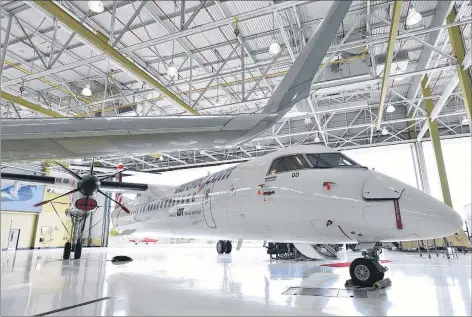  ?? CP PHOTO ?? A Bombardier Q400 jet sits in a hangar at the Bombardier facility in Toronto, Ontario. The head of the British Columbia aviation company that scooped up Bombardier Inc.’s Q400 turboprop business is pledging to keep all manufactur­ing already in Canada within the country.