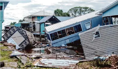  ?? Emily Kask/New York Times ?? Florida assesses the damage on Wednesday after Hurricane Idalia brought destructiv­e winds and lifethreat­ening storm surges before moving inland. Homes in Horseshoe Beach, Fla., were ripped from their foundation­s in the storm’s destructio­n.