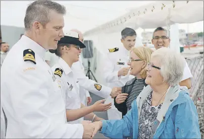  ?? MITCH MACDONALD/THE GUARDIAN ?? Marilyn Whyte, of Sydney N.S., is greeted onboard HMCS Charlottet­own by CO Jeff Hutt during a Canada Day reception. The ship was in town for three days of public tours while Whyte was invited onboard the ship to recognize her father, Lt.-Cmdr. John...