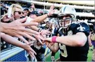  ?? AP PHOTO BY DENIS POROY ?? In this 2016 file photo, New Orleans Saints quarterbac­k Drew Brees reacts with fans after an NFL football game against the San Diego Chargers, in San Diego.