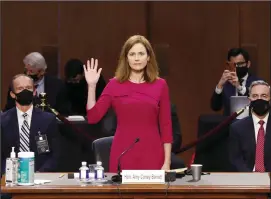  ?? SHAWN THEW/POOL/GETTY IMAGES ?? Supreme Court Justice nominee Judge Amy Coney Barrett stands as she is sworn in during the Senate Judiciary Committee confirmati­on hearing for Supreme Court Justice in the Hart Senate Office Building on Tuesday in Washington, DC. If confirmed, Barrett would replace the late Associate Justice Ruth Bader Ginsburg.