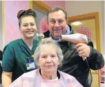  ??  ?? > Radio presenter Kev Johns with healthcare support worker Ceri Brian and patient Pauline Austin at the new salon on Onnen ward, Cefn Coed Hospital