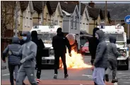  ??  ?? Nationalis­ts attack police close to the peace wall interface gates which divide the nationalis­t and loyalist communitie­s