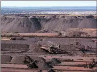  ?? Bloomberg News/WALDO SWIEGERS ?? Stackers drop iron ore into piles in May at the Sishen open cast mine, operated by Kumba Iron Ore in Sishen, South Africa.