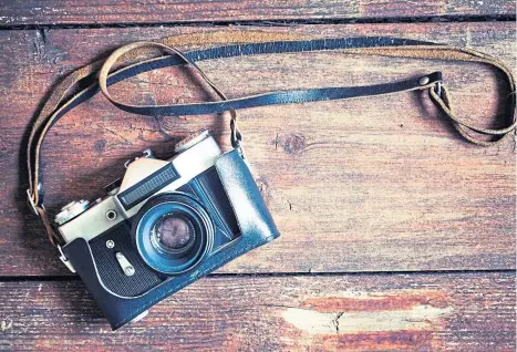  ??  ?? IN THE PICTURE: Photograph­er Rab McNeil looks back over a lifetime of snapshots.