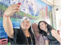 ??  ?? LEFT Cancer patients take a selfie with Ms Panita after they joined a class she taught on how to wrap a scarf fashionabl­y around their heads.