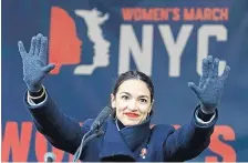  ?? KATHY WILLENS/ASSOCIATED PRESS ?? U.S. Rep. Alexandria Ocasio-Cortez, (D-N.Y.) speaks at a rally in New York last month. She is calling for a Green New Deal intended to transform the U.S. economy to combat climate change.