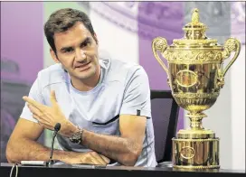  ?? ADAM DAVY / ASSOCIATED PRESS ?? Roger Federer’s comments at the Wimbledon trophy presentati­on hinted he might not return, but he later said he just “can’t think too far ahead.”