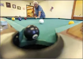  ?? (River Valley Democrat-Gazette/Hank Layton) ?? Jerry Belrose plays pool with other visitors Friday at the Betty Wilkinson Senior Activity Center in
Greenwood.